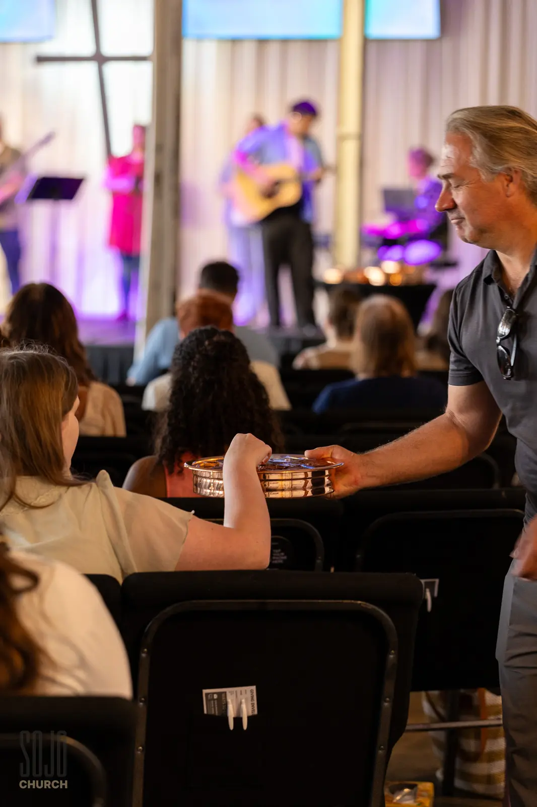 Communion passed down the rows on the first Sunday at Gibson Mill
