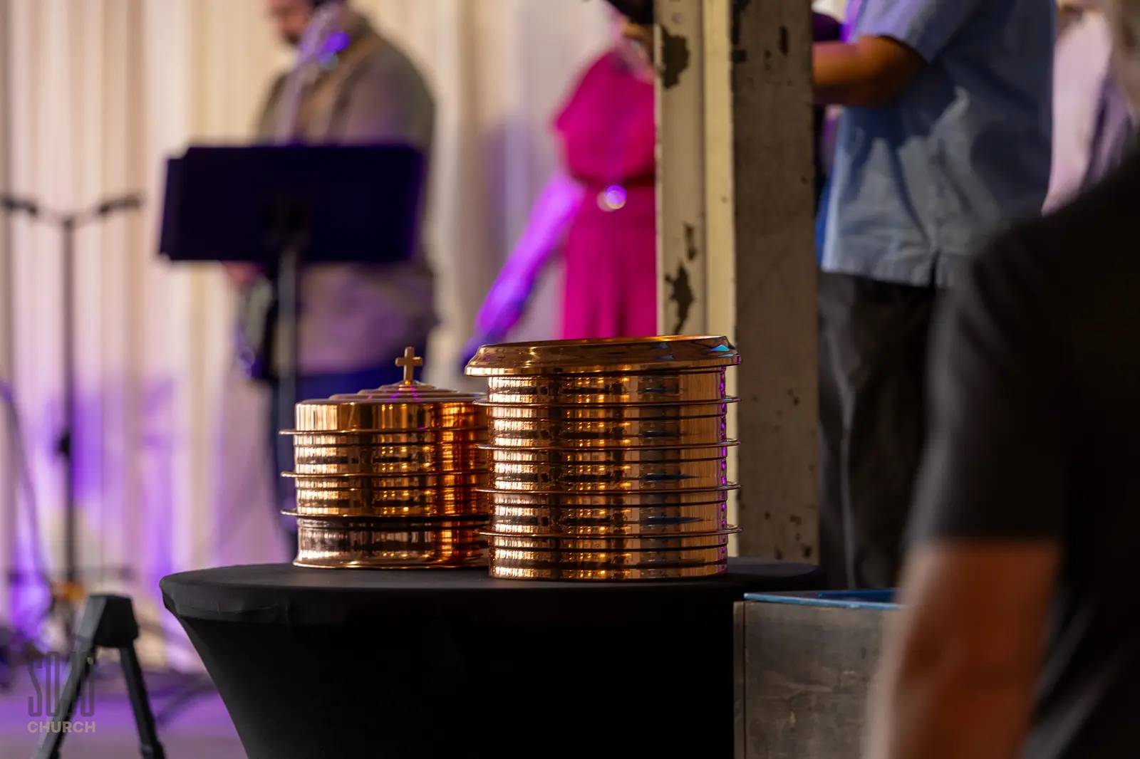 Copper communion trays stacked on a table before the service