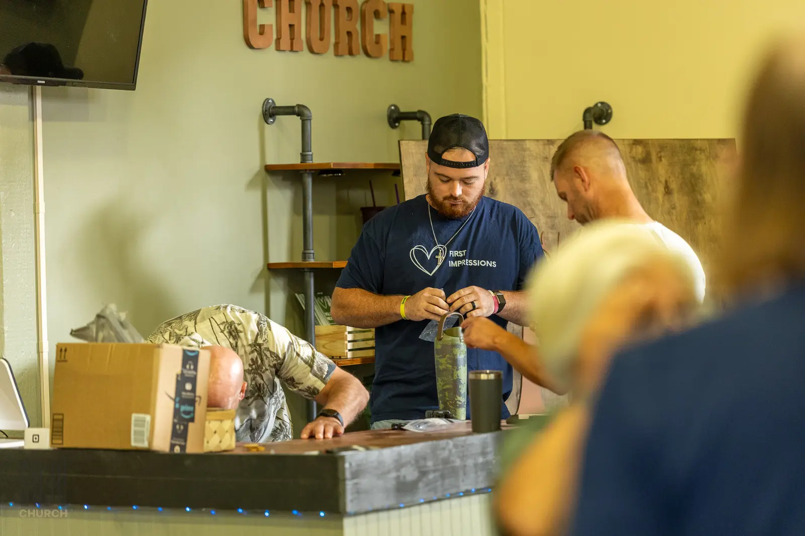The First Impressions team setting up the guest counter on Sunday morning