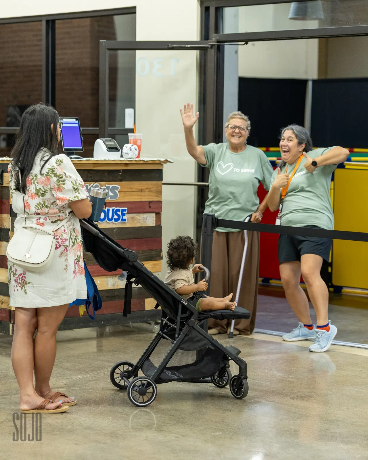A family welcomed at the SOJO Kids check-in on Sunday morning