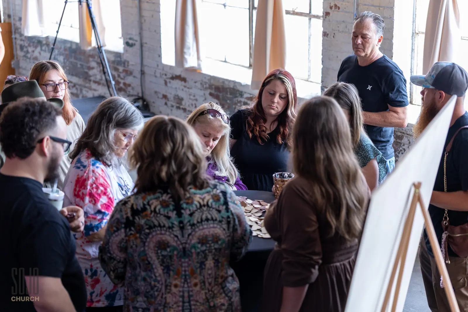 People gathered around a table together after the service