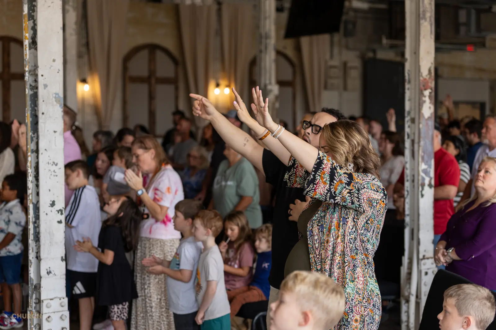 The SOJO congregation worshipping among the original mill columns