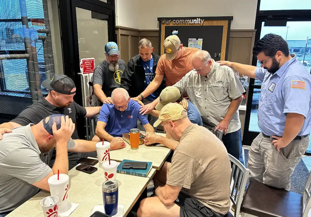 A SOJO Community Group praying over one of their own
