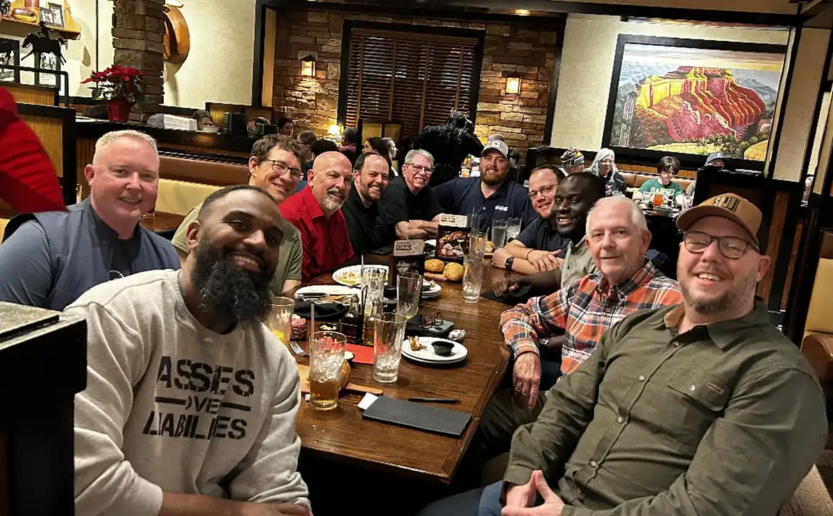 A SOJO group around a long dinner table