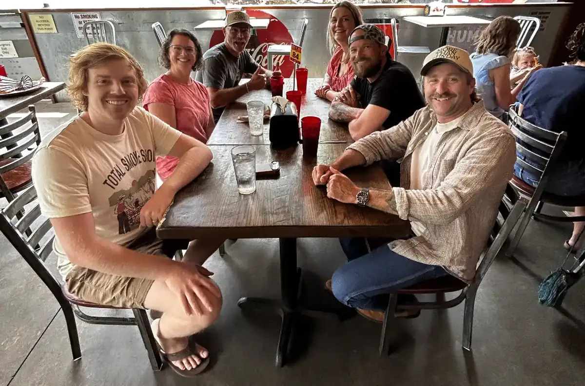 A SOJO group sharing a meal around a table