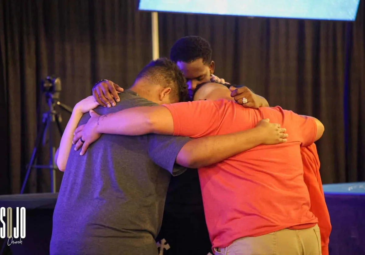 People embracing after a SOJO service