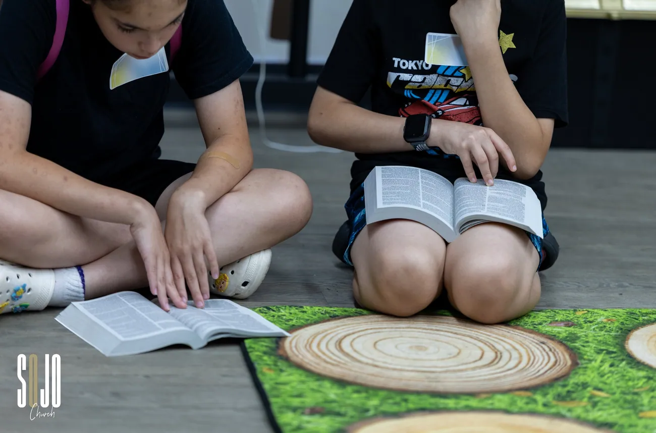 Two SOJO Kids reading their Bibles together