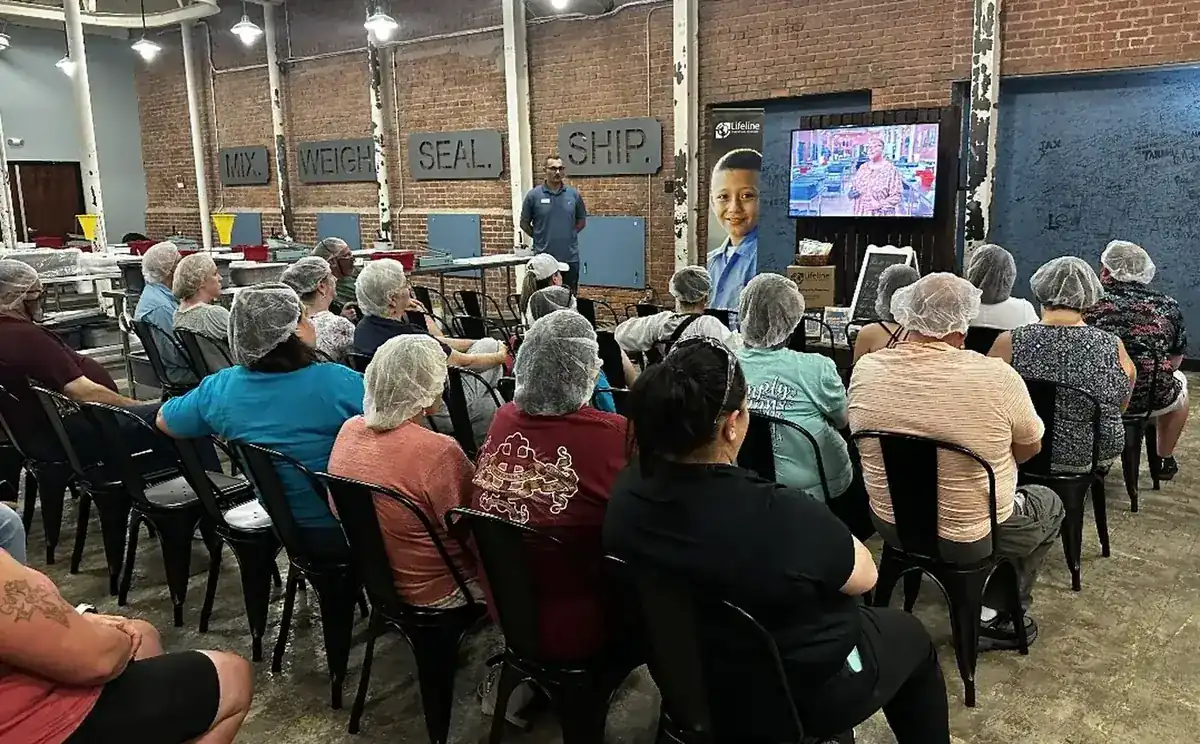SOJO volunteers being briefed before a Lifeline meal packing session