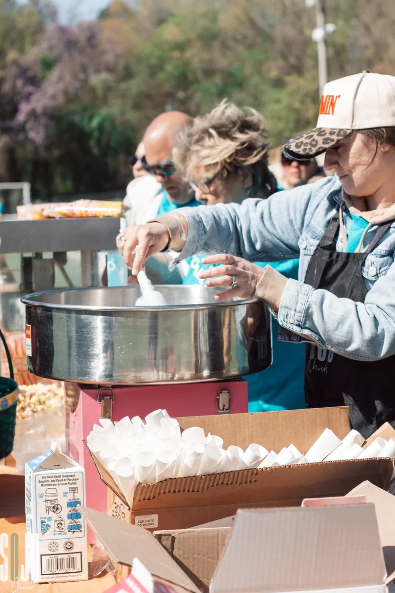 SOJO volunteers spinning cotton candy at a community outreach event
