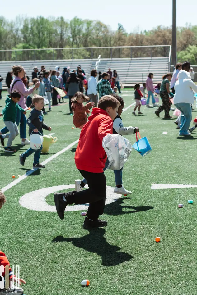 Kids racing for eggs at the SOJO community egg hunt in Concord