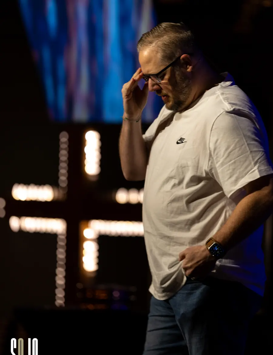 A man praying during a service at SOJO Church