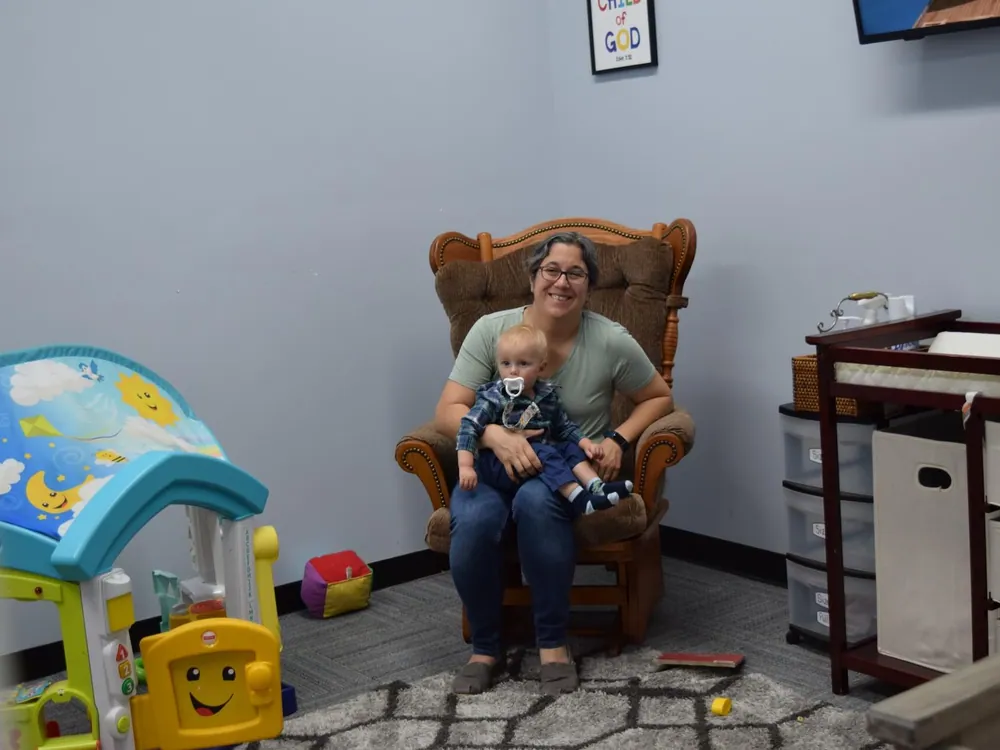 A volunteer caring for an infant in the SOJO nursery