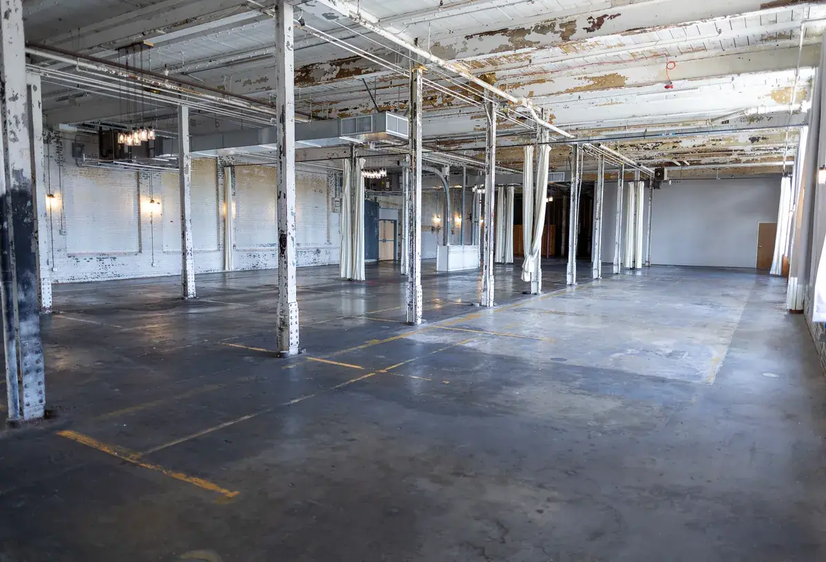 Original ceiling and hanging lights in the mill space