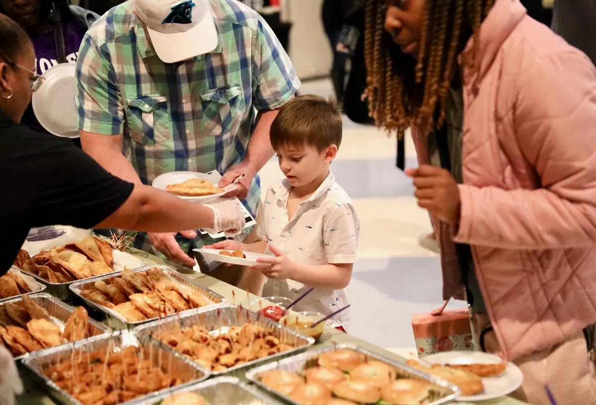 A boy being served food at a SOJO gathering