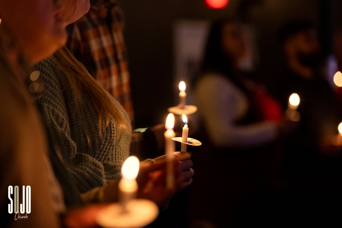Candles held in a dark room at SOJO
