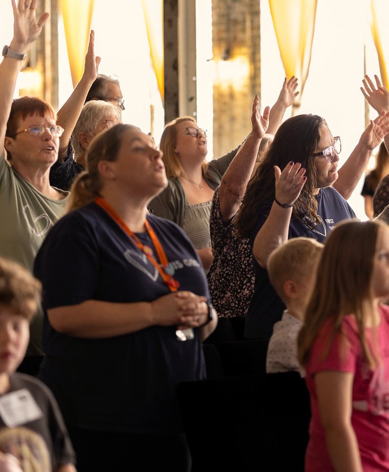 The room on a Sunday morning at SOJO, hands raised and kids up front