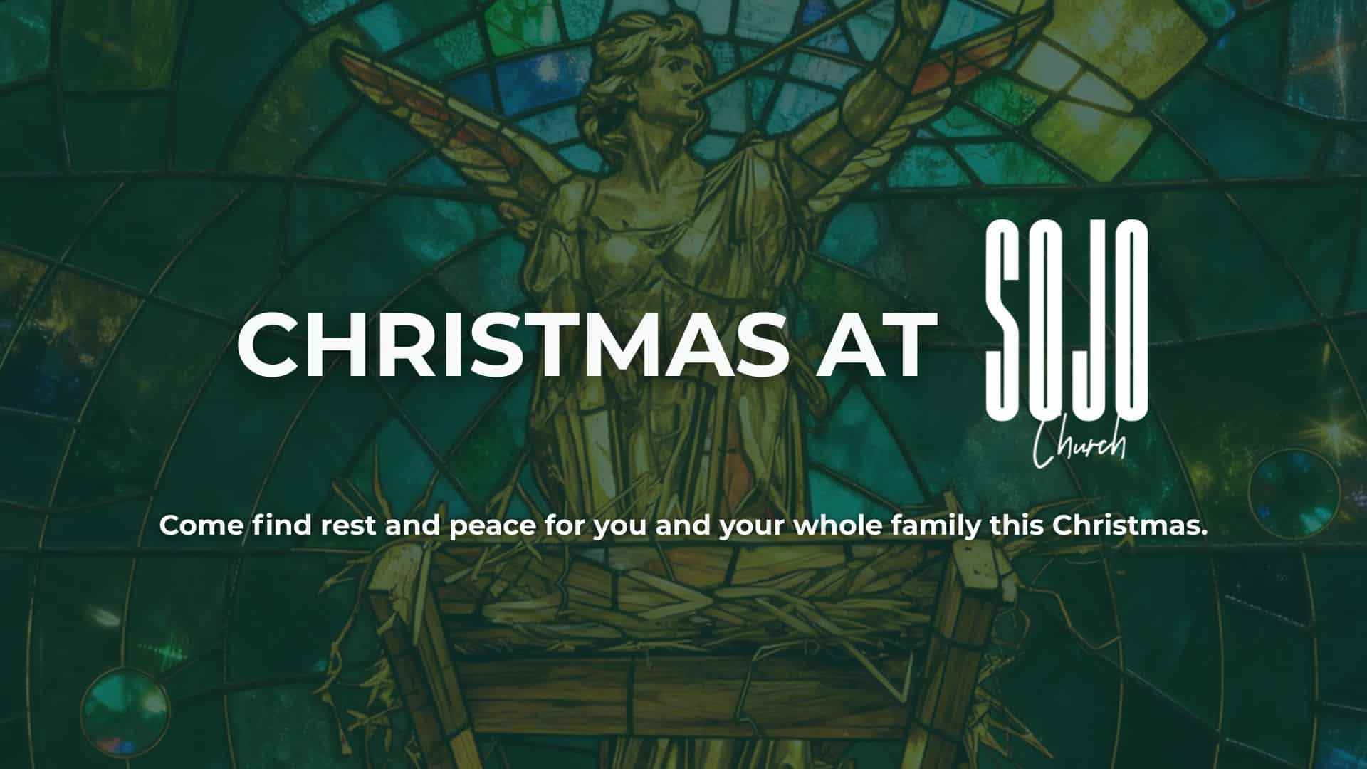 Stained glass angel with Christmas message from church.